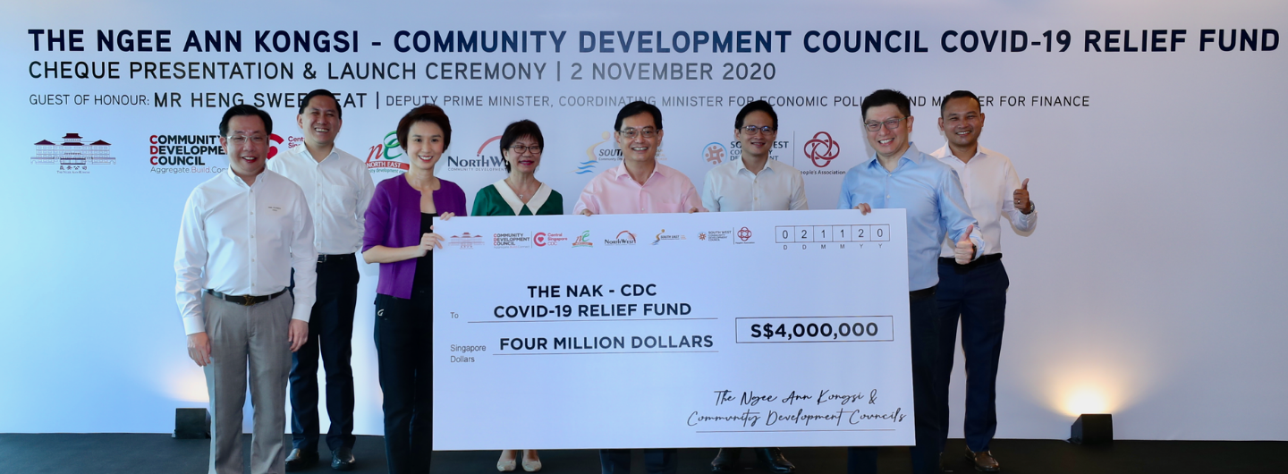Group of people holding a large check for $4,000,000 for "The NAK - CDC COVID-19 Relief Fund."